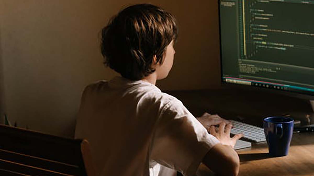 boy looking at code image of boy looking at code