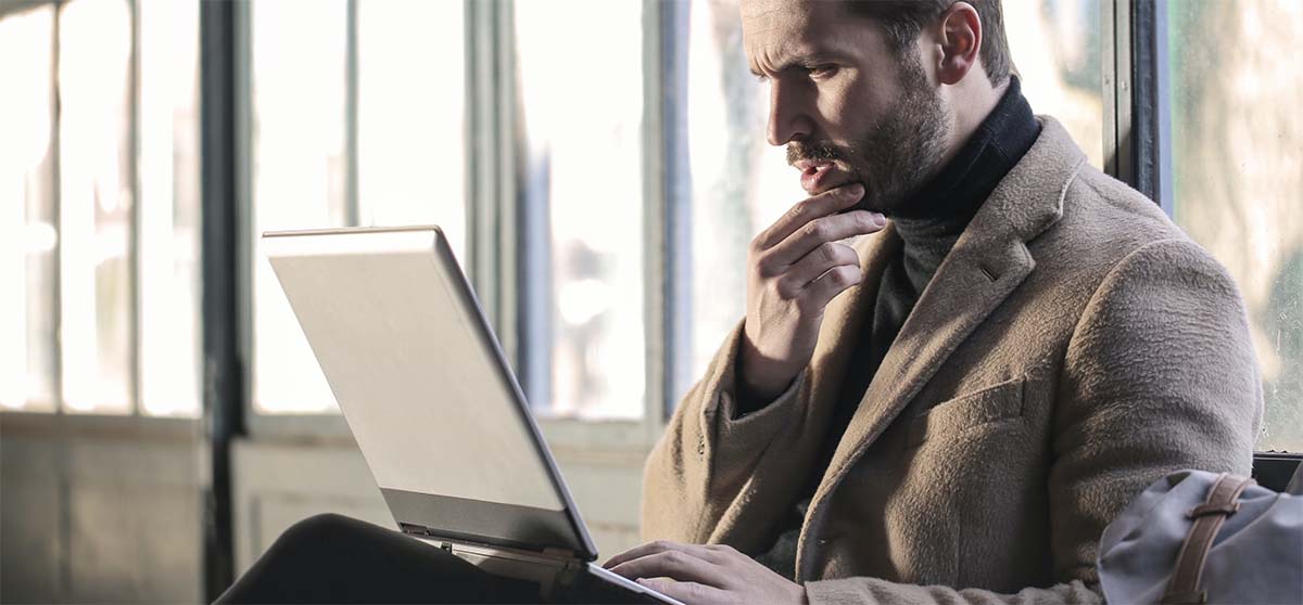 man-thinking-laptop image man looking at laptop in thought