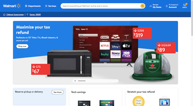 Walmart home page A screenshot of the Walmart home page shows a blue header bar with the logo, navigation, wide search bar, and account links. The hero image reads “Maximize your tax refund” and has photos of a microwave, carpet cleaner, and Roku TV.