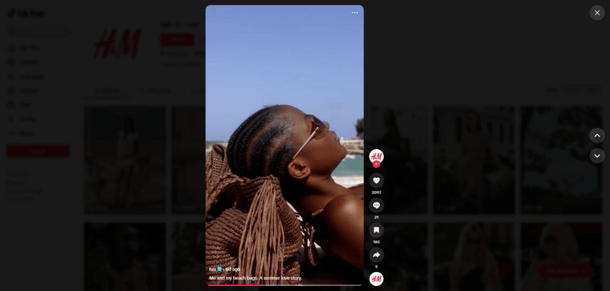 H&M TikTok video On H&M’s TikTok page is a video of a woman wearing sunglasses. She lies back on a brown bag with the ocean behind her. The caption reads: “Me and my beach bags. A love story.”